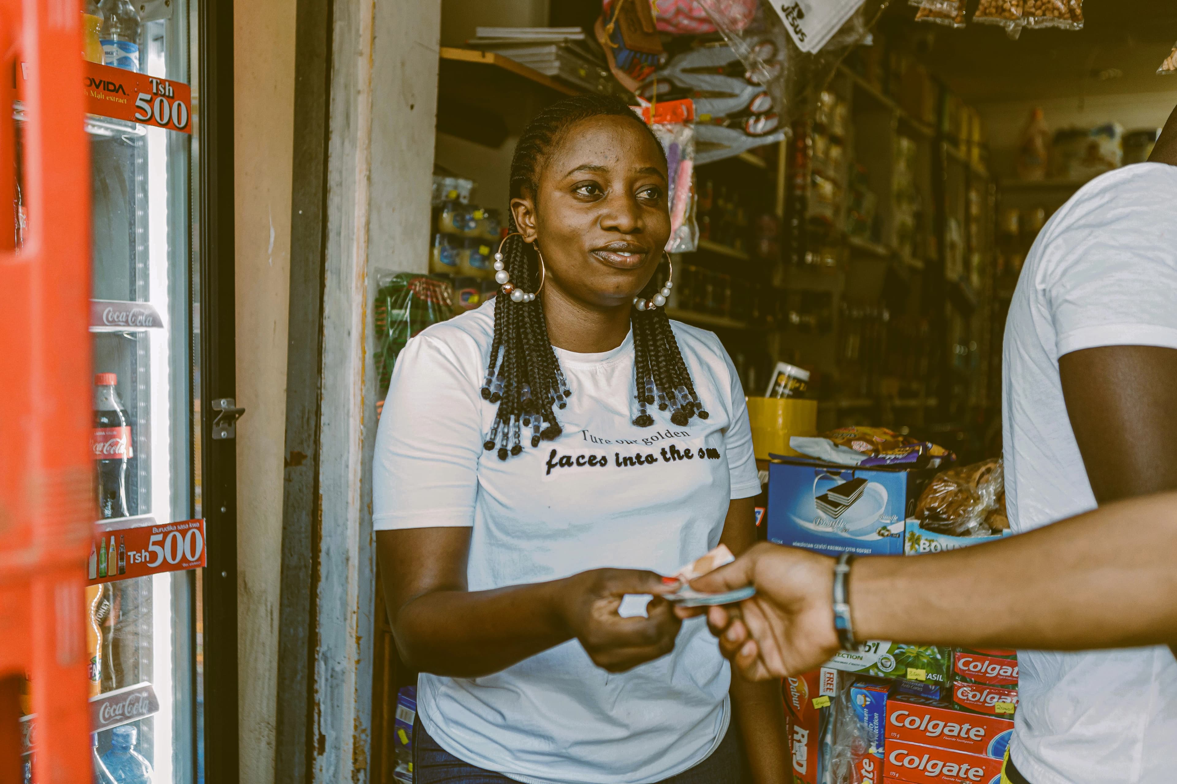A shopkeeper taking payment from a customer